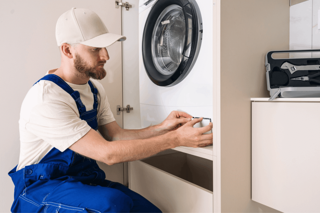 technician repairing washing machine - A Aplus appliance repair solutions